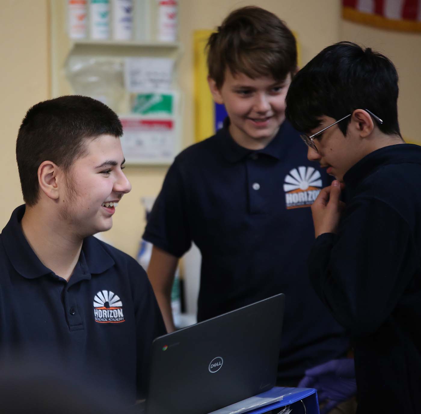 HSA Dayton Downtown student drawing at a desk in a classroom setting